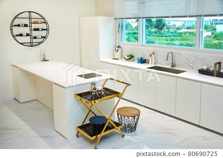 Table and dining table in a clean and simple modern open kitchen Table and dining table in a clean and simple modern open kitchen 80690725