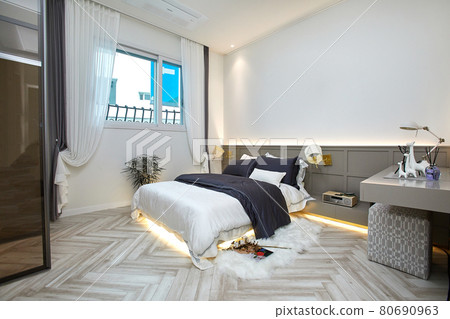 A room with a nice interior, with a bed and a blanket A room with a nice interior, with a bed and a blanket 80690963