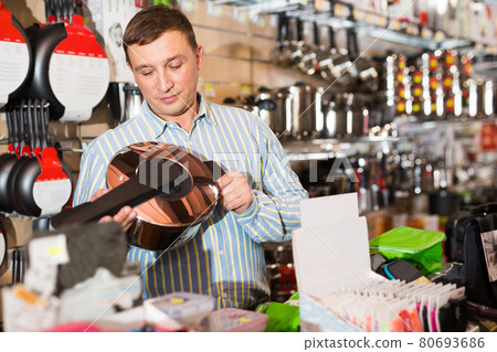Man buying household appliances Man buying household appliances 80693686