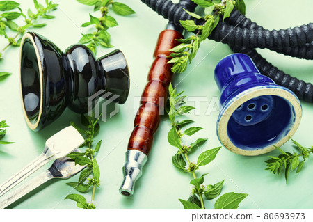 Smoking hookah with fresh mint 80693973