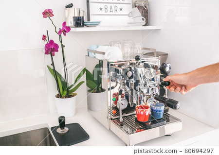 Coffee machine man barista making two espresso at home kitchen lifestyle. Morning breakfast Professional equipment at home or office 80694297