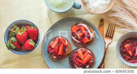Vegan buckwheat gluten free pancakes breakfast served with chia strawberry jam and dairy free yogurt 80695308