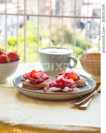 Vegan buckwheat gluten free pancakes breakfast served with chia strawberry jam and dairy free yogurt 80695309