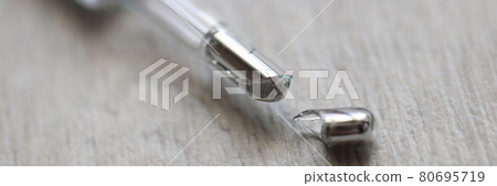 Broken mercury thermometer lies on floor closeup 80695719