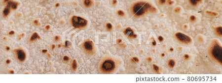 Toasted sweet flour pancake closeup. Fast cooking pancakes for breakfast Toasted sweet flour pancake closeup. Fast cooking pancakes for breakfast 80695734