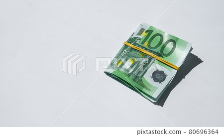 Close up of Euro money roll. Euro banknote set cash money - EU currency. Rolled with rubber euro notes. Banknotes stacked on each other in different positions Close up of Euro money roll. Euro banknote set cash money - EU currency. Rolled with rubber euro notes. Banknotes stacked on each other in different positions 80696364