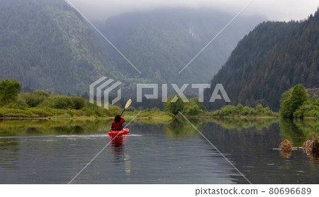 Adventure Caucasian Adult Woman Kayaking in Red Kayak 80696689