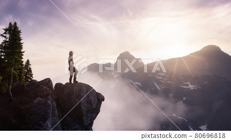 Fantasy Adventure Composite with a Woman on top of a Mountain 80696818