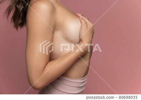 Cropped image of female body isolated on pink studio background. Natural beauty, treatment, healthcare, wellness, well-kept skin concept. Side view Cropped image of female body isolated on pink studio background. Natural beauty, treatment, healthcare, wellness, well-kept skin concept. Side view 80698035