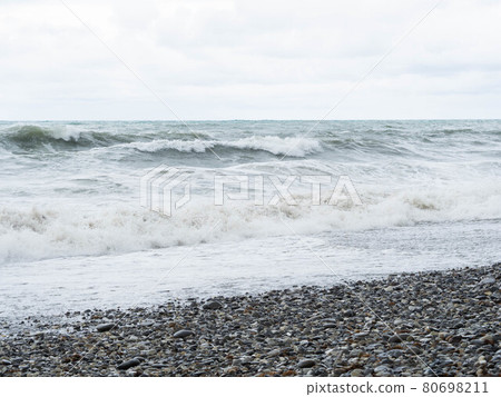 Storm waves on a stone beach in cloudy weather. Nature scenery 80698211