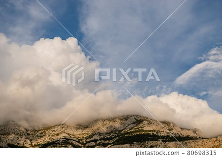 Beautiful low clouds lie on the mountains, Brela Croatia Beautiful low clouds lie on the mountains, Brela Croatia 80698315