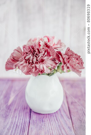 Tea rose color carnation flowers on a wooden background, copy space Tea rose color carnation flowers on a wooden background, copy space 80698319