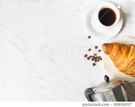 Flat lay frame of cups of coffee and croissant on marble background Flat lay frame of cups of coffee and croissant on marble background 80699207