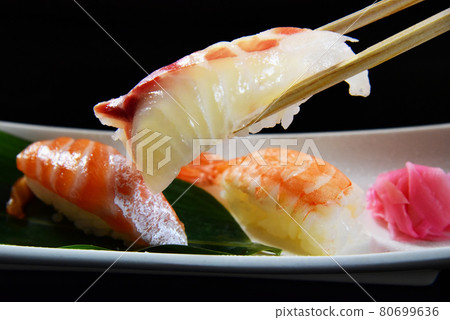 Nigiri sushi grab the sea bream with chopsticks Nigiri sushi grab the sea bream with chopsticks 80699636