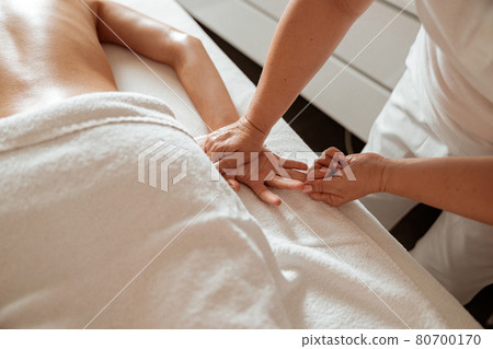Masseuse massaging woman hand in spa salon Masseuse massaging woman hand in spa salon 80700170