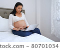 Young Asian beautiful pregnant woman using laptop in the bedroom. working form home. freelance concept 80701034