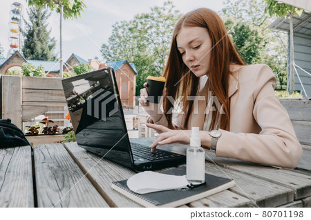 Data privacy, data wellbeing, management, personal information, digital identity, digital behavior, security issue, data hygiene, cybersecurity. Redhead woman entering data on laptop 80701198
