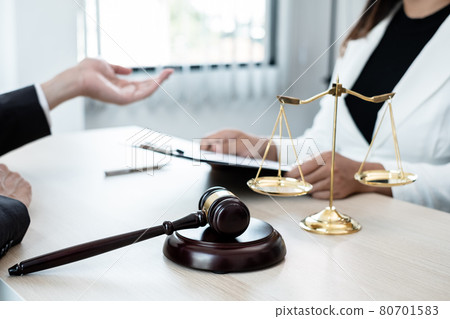 A male lawyer or a judge counseling clients about judicial justice and prosecution with scales, judges gavel, legal documents legal services concept A male lawyer or a judge counseling clients about judicial justice and prosecution with scales, judges gavel, legal documents legal services concept 80701583