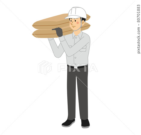 A man at a construction site carrying a sandbag 80701883