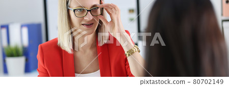 Two businesswoman chatting at working table closeup 80702149