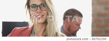 Portrait of smiling businesswoman at workplace in office Portrait of smiling businesswoman at workplace in office 80702200