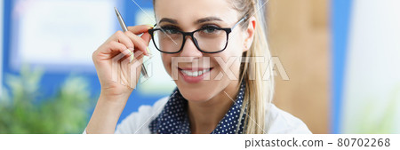Portrait of smiling female doctor with glasses Portrait of smiling female doctor with glasses 80702268