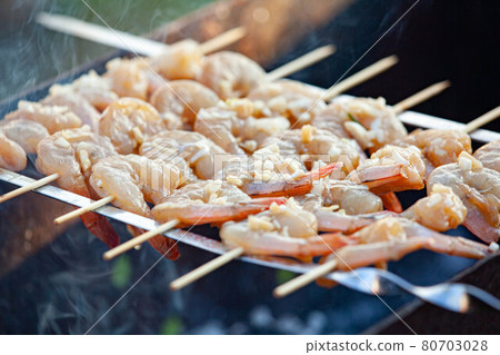 Shrimp grilling over an open flame Shrimp grilling over an open flame 80703028