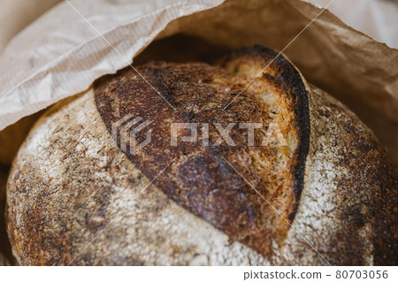 Beautiful bread close-up. Bread from shop in craft package. Grain surface texture. 80703056