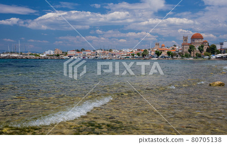Clear waters of Mediterranean sea and a beautiful view of Aegina town in Aegina island, Saronic gulf, Greece. Clear waters of Mediterranean sea and a beautiful view of Aegina town in Aegina island, Saronic gulf, Greece. 80705138
