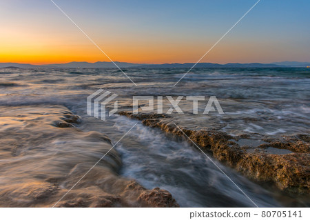Beautiful sunset at Mediterranean Sea with wild and rocky beaches Beautiful sunset at Mediterranean Sea with wild and rocky beaches 80705141