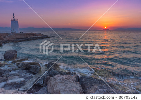 Old small lighthouse of the Aegina island, Saronic gulf, Greece, at sunset. Old small lighthouse of the Aegina island, Saronic gulf, Greece, at sunset. 80705142