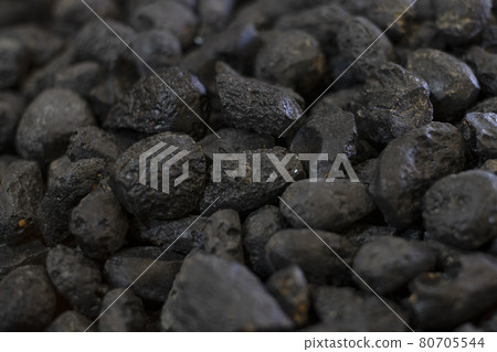 Black tektite stone or meteorite as background 80705544