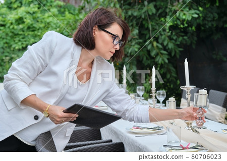 Organization of weddings, parties, catering for events. Female on the background banquet decorated table, table setting decoration 80706023