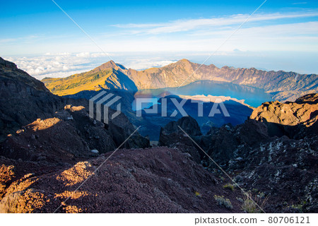 Mount Rinjani crater and a shadow cast from the peak at sunrise Mount Rinjani crater and a shadow cast from the peak at sunrise 80706121