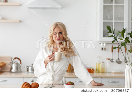 Wake up early, lazy morning, tasty coffee before work for good mood, facial expression 80706887