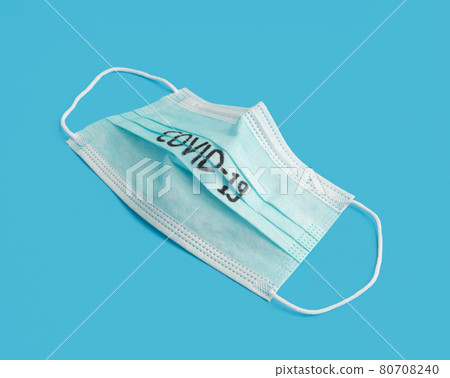 Face mask isolated on blue background. Face covering. Virus protection. Medical and healthcare. Coronavirus covid-19 outbreak. Face mask isolated on blue background. Face covering. Virus protection. Medical and healthcare. Coronavirus covid-19 outbreak. 80708240