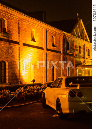 Sports car illuminated by red brick Sports car illuminated by red brick 80708445