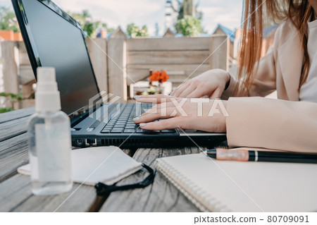 Data privacy, data wellbeing, management, personal information, digital identity, digital behavior, security issue, data hygiene, cybersecurity. Redhead woman entering data on laptop 80709091