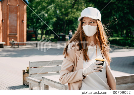 Food and drink businesses during coronavirus pandemic. Coffee to go takeaway cup in female hands in gloves. Restaurants, pubs, bars, nightclubs and takeaway services working safely during coronavirus 80709092