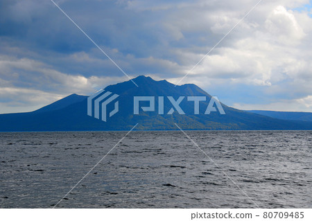 Another angle overlooking Mt. Fuppushi and Mt. Tarumae from the coast of Lake Shikotsu Another angle overlooking Mt. Fuppushi and Mt. Tarumae from the coast of Lake Shikotsu 80709485