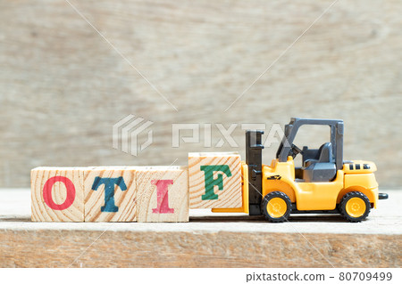 Toy forklift hold letter block f to complete word OTIF (abbreviation of On Time In Full) on wood background Toy forklift hold letter block f to complete word OTIF (abbreviation of On Time In Full) on wood background 80709499