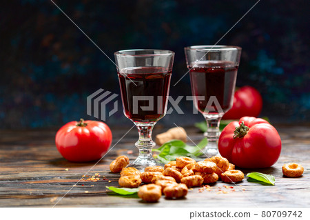 Taralli with tomatoes and glasses of wine. 80709742