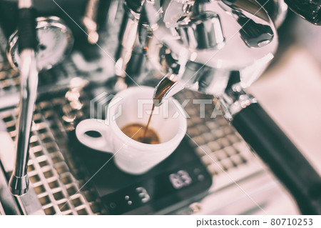 Espresso machine at cafe bar barista making single shot lungo. Closeup of cup on scale Espresso machine at cafe bar barista making single shot lungo. Closeup of cup on scale 80710253