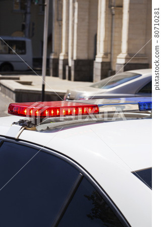 a police car with red and blue sirens at the checkpoint. Police work. a police car with red and blue sirens at the checkpoint. Police work. 80710281
