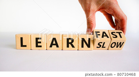 Learn slow or fast symbol. Businessman turns wooden cubes and changes words 'learn slow' to 'learn fast'. Beautiful white background, copy space. Business and learn slow or fast concept. Learn slow or fast symbol. Businessman turns wooden cubes and changes words 'learn slow' to 'learn fast'. Beautiful white background, copy space. Business and learn slow or fast concept. 80710468