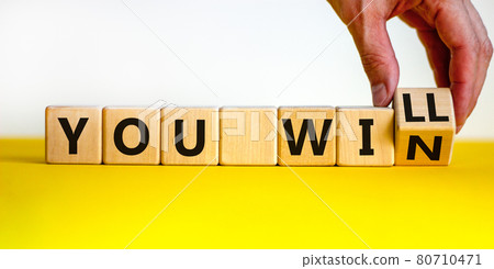 You will win symbol. Businessman turns cubes and changes words you will to you win. Beautiful yellow table, white background, copy space. Business, motivational and you will win concept. You will win symbol. Businessman turns cubes and changes words you will to you win. Beautiful yellow table, white background, copy space. Business, motivational and you will win concept. 80710471