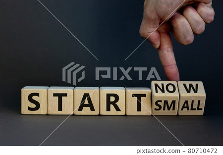 Start small and now symbol. Businessman turns wooden cubes and changes words 'start small' to 'start now'. Beautiful grey background, copy space. Business and start small and now concept. Start small and now symbol. Businessman turns wooden cubes and changes words 'start small' to 'start now'. Beautiful grey background, copy space. Business and start small and now concept. 80710472