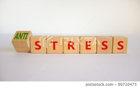 Antistress vs stress symbol. Turned cubes and changed the word stress to anti stress. Beautiful white table, white background. Medical, psychological, antistress vs stress concept. Copy space. 80710473