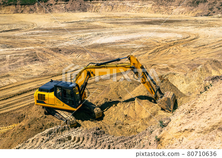 Closeup of an industrial excavator working in a cave quarry. Industry, technology, mining. Heavy 80710636