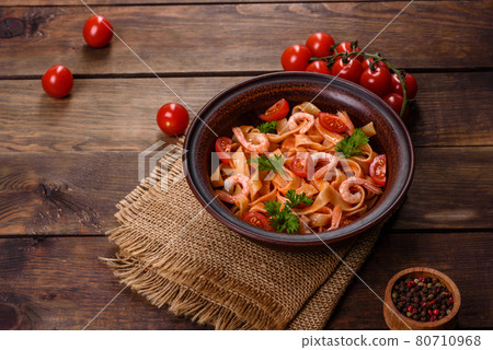 Fettuccine pasta with shrimp, cherry tomatoes, sauce, spices and herbs Fettuccine pasta with shrimp, cherry tomatoes, sauce, spices and herbs 80710968
